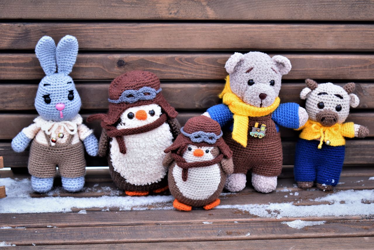Mastering the First Impression: Your intriguing post title goes here A charming collection of handmade crochet toys on a wooden bench in winter, showcasing unique designs.