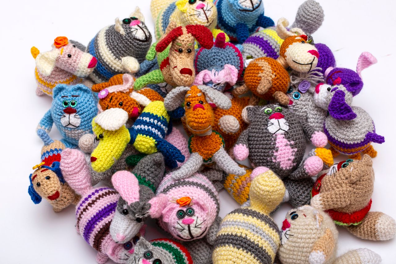 The Art of Drawing Readers In: Your attractive post title goes here Vibrant assortment of handmade knit stuffed animal toys arranged together, showcasing intricate designs and bright colors.